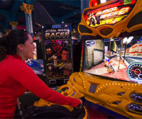 Woman playing arcade game