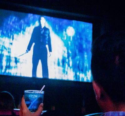 Person with drink watching movie