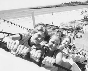 Black and white photo of people on Giant Dipper rollercoaster