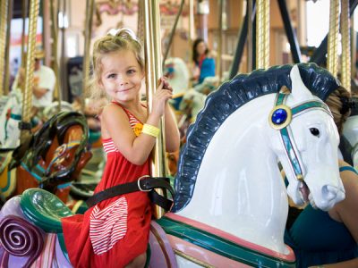 Girl riding Looff Carousel