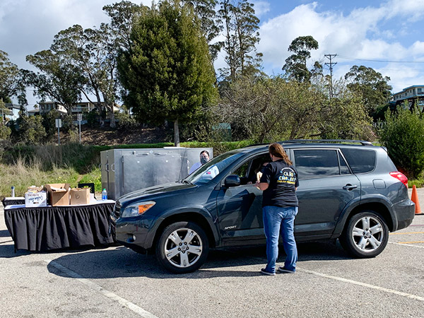 Woman standing next to SUV