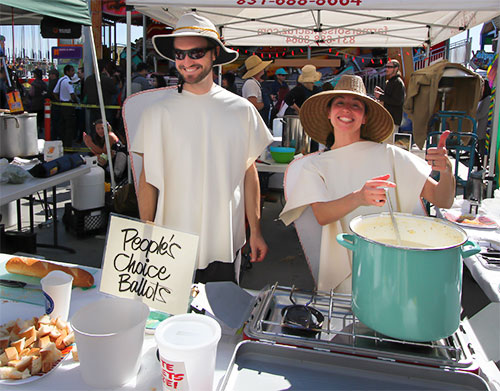 Team cooking chowder and smiling
