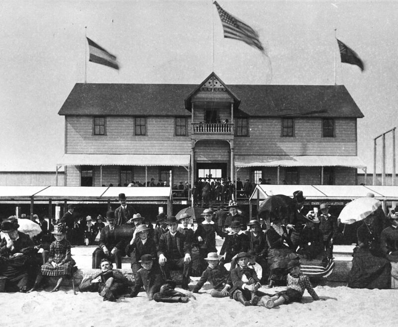 On June 10, 1884, beachgoers enjoy the dedication of the Neptune Bath House built by Captain C.F. Miller.